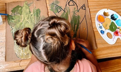 girl painting in online preschool classes