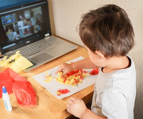 boy doing art project in interactive online preschool classes