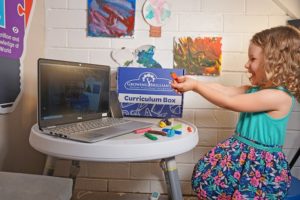 child sculpting clay during online preschool