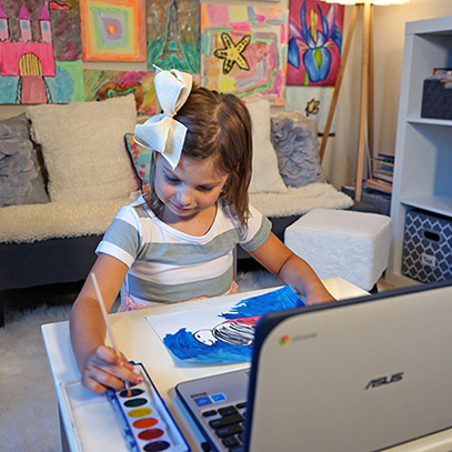 girl painting in online preschool class